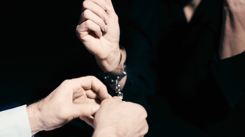 Policeman Removing Handcuffs - Criminal Charges Dropped