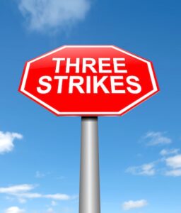 Three-Strikes Law Concept Stop Sign
