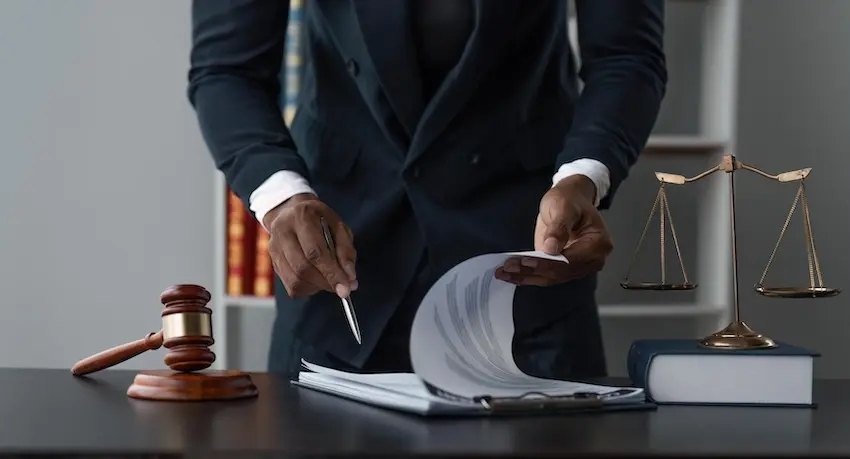 Defense attorney reviewing criminal case evidence and police reports for effective legal defense strategy