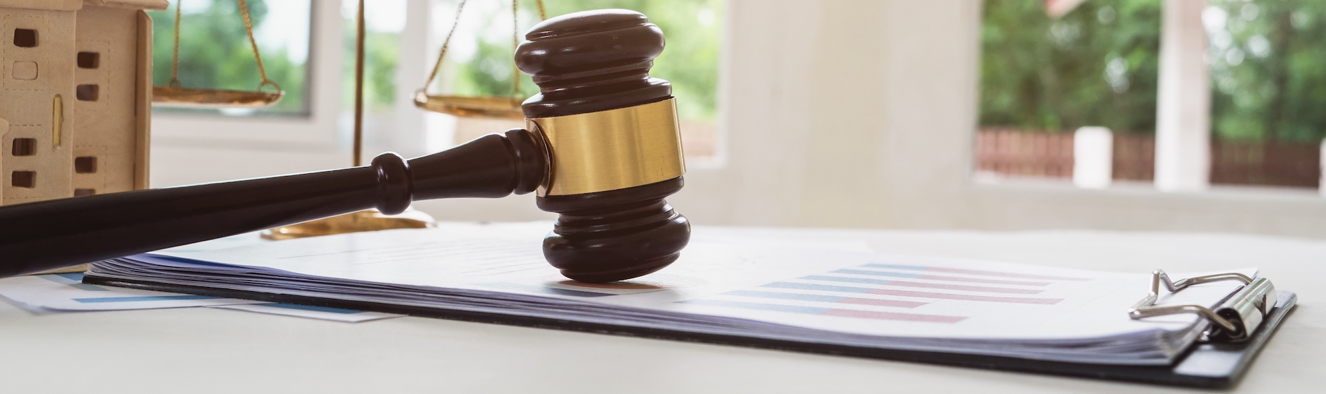 A judge's gavel and legal documents representing criminal defense tactics used in courtroom proceedings