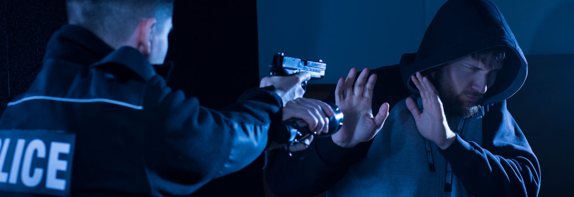 A police officer is arresting a suspect demonstrating how to fight criminal charges through proper legal representation.