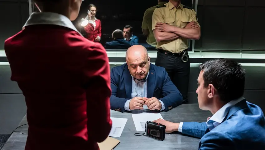 A scene with a suspect seated across from two attorneys from Byron Pugh Legal beside a recording device depicting the critical early stages of a criminal case where legal strategy begins to shape criminal defense outcomes in Tennessee.